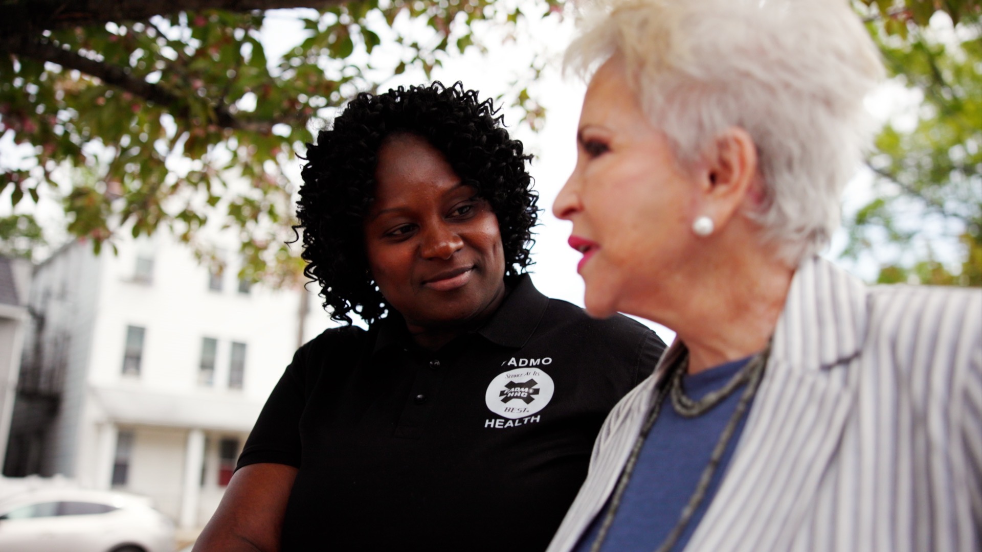 FADMO caregiver in conversation with a client outdoors